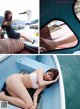 A woman in a pink bikini sitting on a boat.