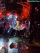 A naked woman standing inside of a large glass sculpture.