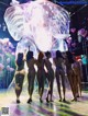 A group of naked women standing in front of a giant bubble.