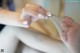 A close up of a person's hands holding a piece of fabric.