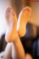 A close up of a woman's feet in sheer stockings.