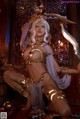A woman in a bikini holding a sword in her hand.