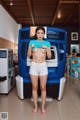 A woman standing in front of a vending machine.