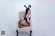 A woman in a bunny costume sitting on a chair.