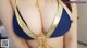 A woman wearing a blue and gold bikini top.