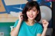 A woman in a blue shirt posing for a picture.